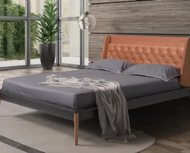 Letto con testiera avvolgente in tessuto imbottito e trapuntato lavorazione capitonnè e base modernista in legno Roma di Novaluna